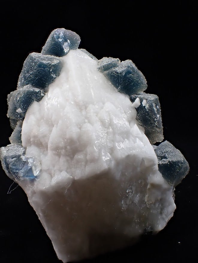 Crowned in Frost: Octahedral Blue Fluorite on Candle Quartz