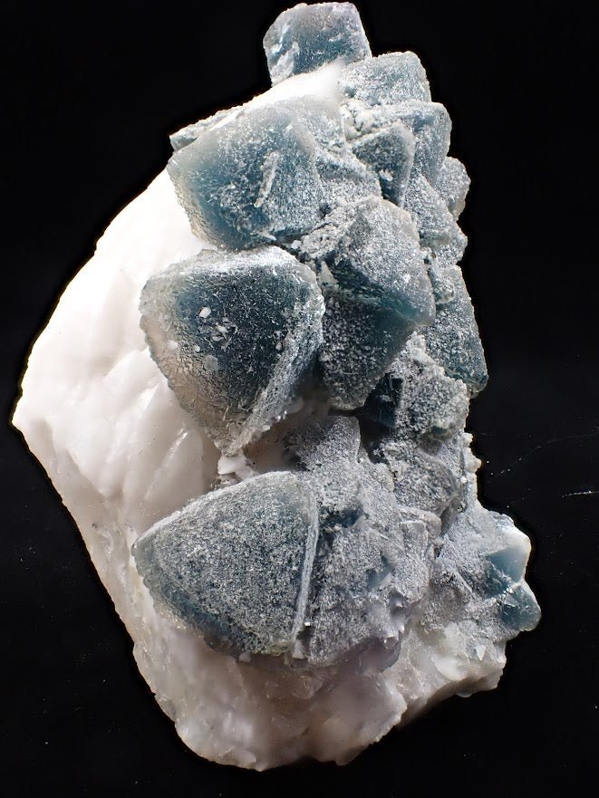 Crowned in Frost: Octahedral Blue Fluorite on Candle Quartz