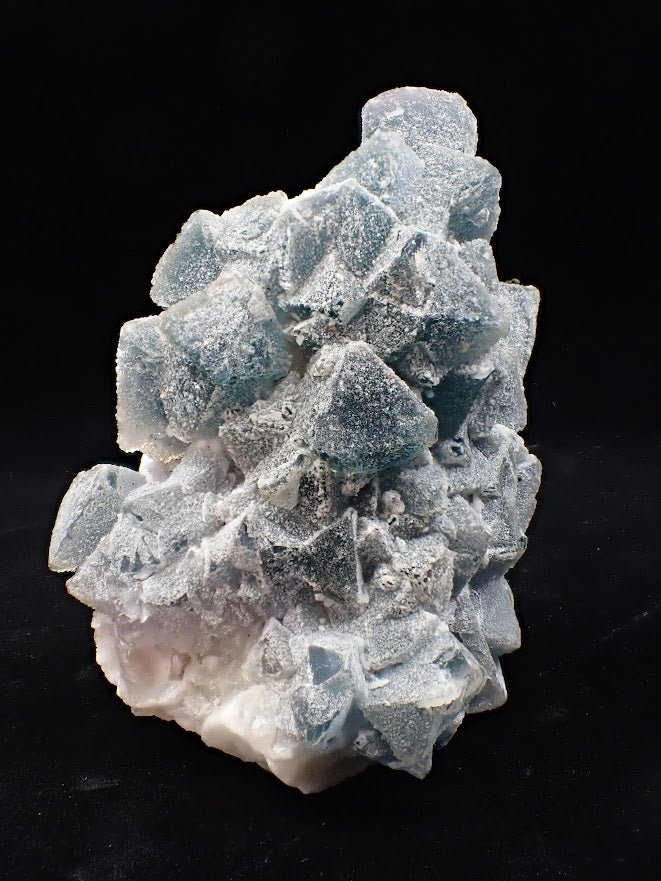 Crowned in Frost: Octahedral Blue Fluorite on Candle Quartz