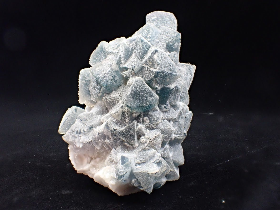 Crowned in Frost: Octahedral Blue Fluorite on Candle Quartz