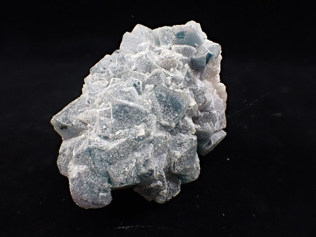 Crowned in Frost: Octahedral Blue Fluorite on Candle Quartz