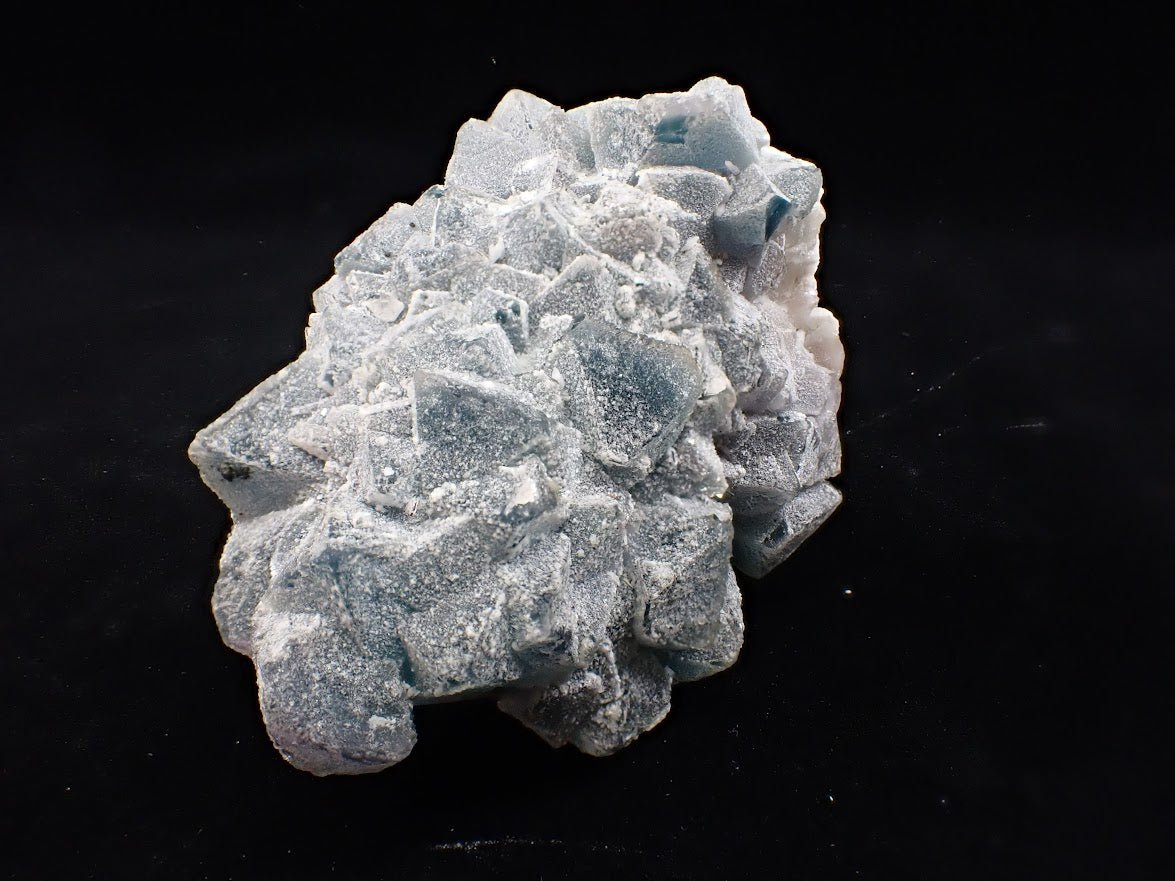 Crowned in Frost: Octahedral Blue Fluorite on Candle Quartz